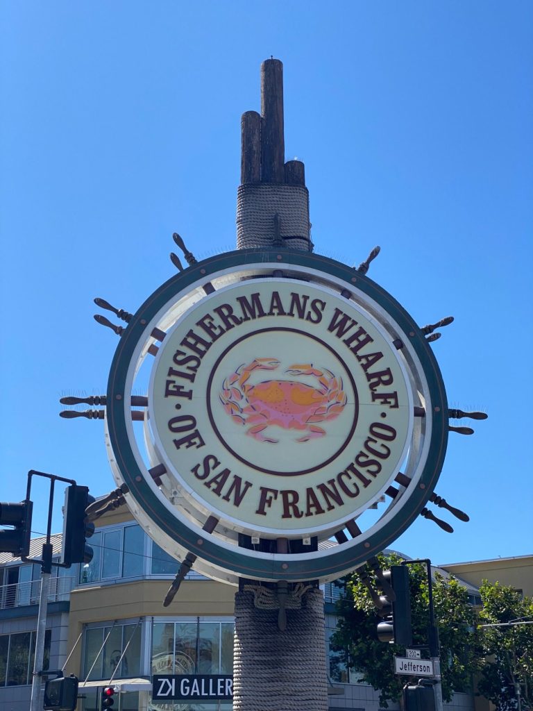 Sign for Fisherman's Wharf in San Francisco, featuring a crab graphic.