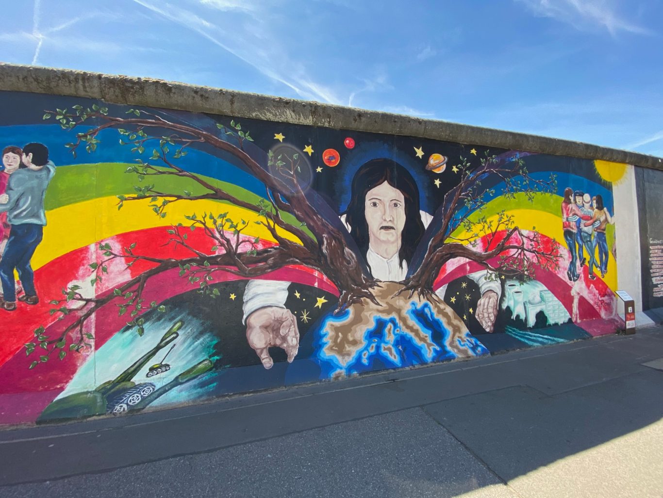 Europas Frühling (Europe's Spring) Colourful mural featuring figures and trees with vibrant rainbow colours and artistic elements.