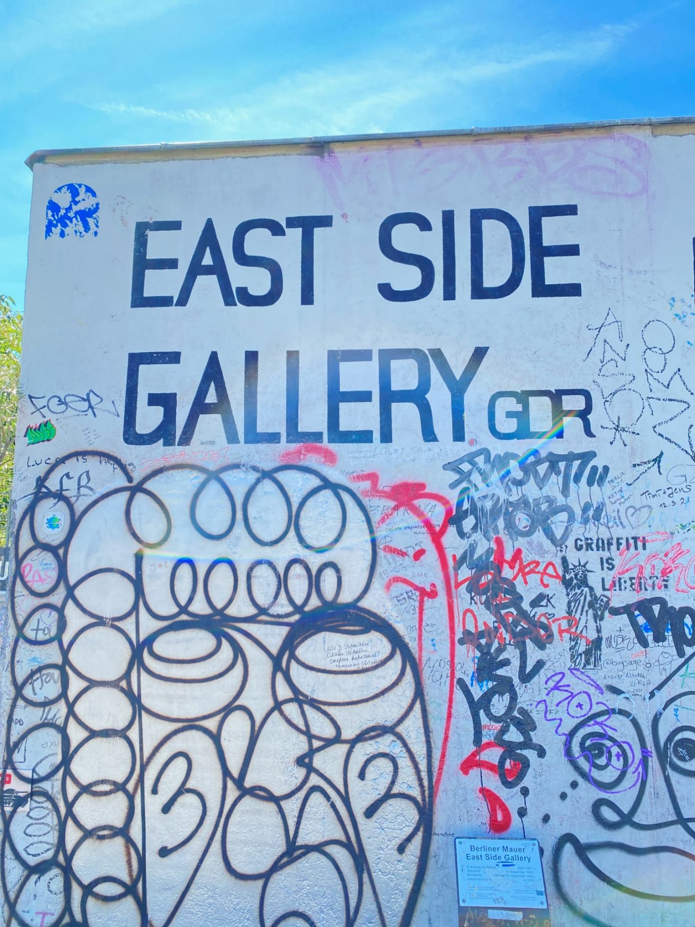 East Side Gallery Graffiti wall featuring the text "EAST SIDE GALLERY" with colourful markings and designs.