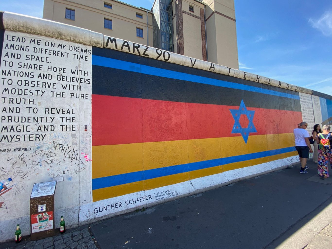 Vaterland (Fatherland) Mural featuring a black, red, and yellow design with a blue star, set against a building backdrop.