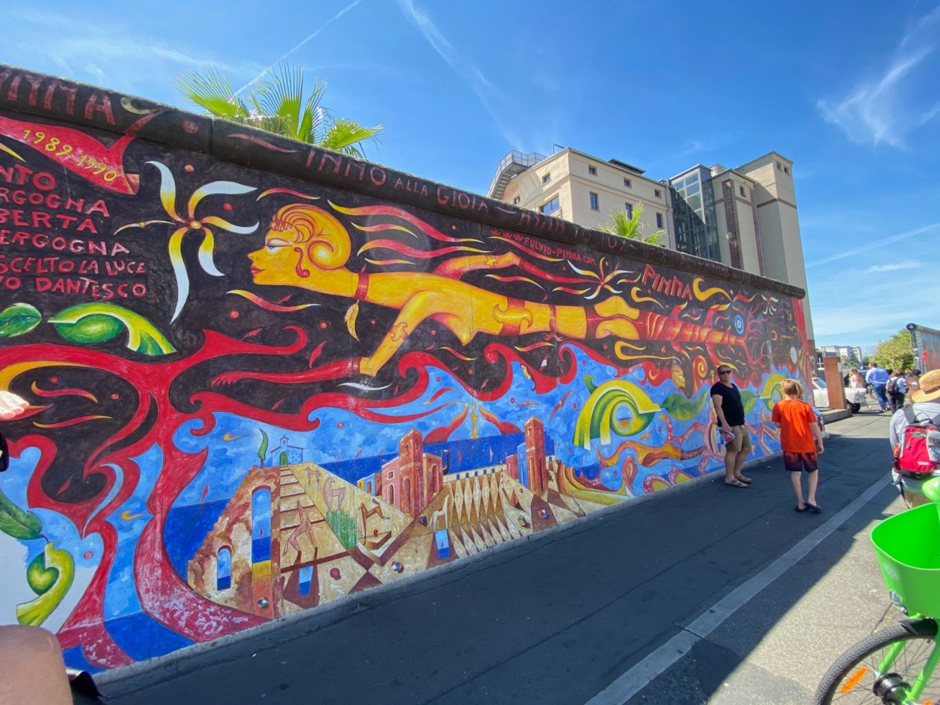 Inno alla Gioia (Ode to Joy) Vibrant mural depicting a figure flying over a landscape with vivid colours and patterns.