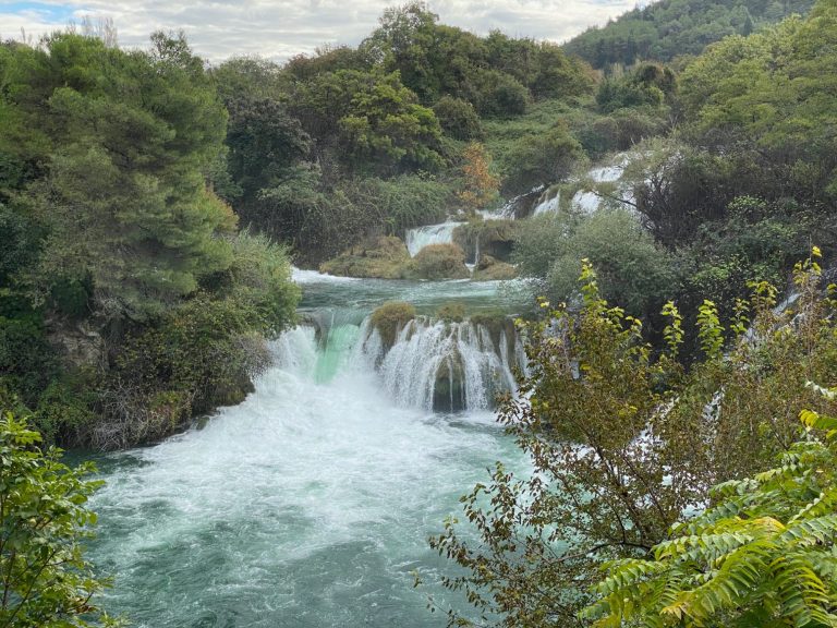 Skradinski Buk Waterfall Serene waterfall surrounded by lush greenery and rocky terrain.