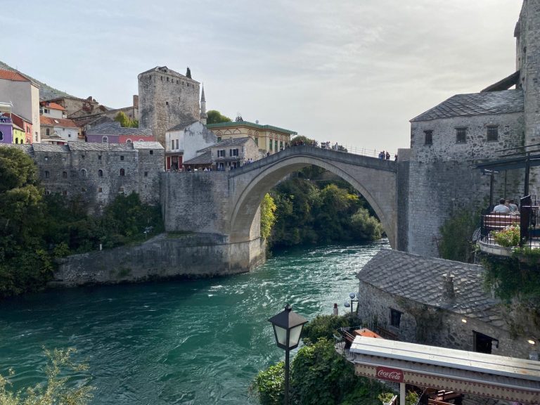 Stari Most (Old Bridge) Stone bridge arching over a turquoise river with historic buildings on riverbanks.