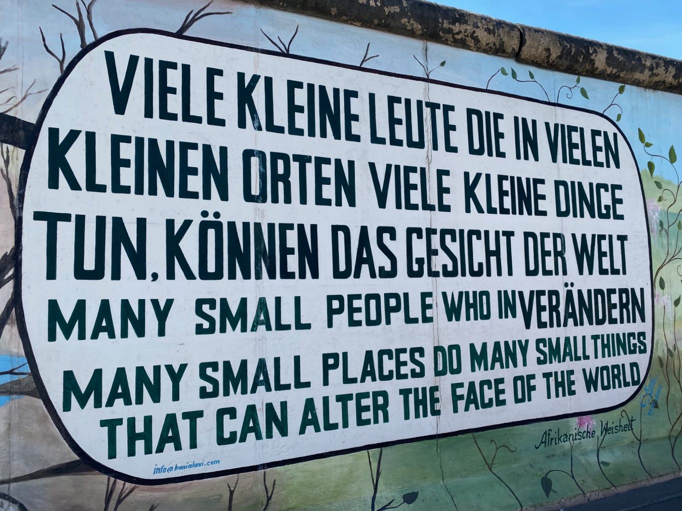 Afrikanische Weisheit (African wisdom) Text from a mural: "Many small people in small places can alter the face of the world."