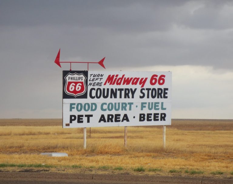 Sign for Midway 66 Country Store, featuring food court, fuel, pet area, and beer.
