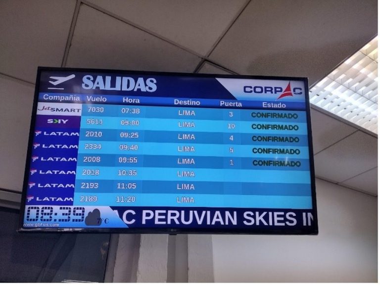 Departure board displaying flight information and statuses at an airport.