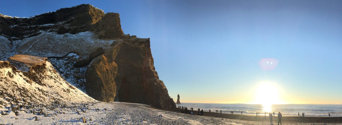 Coastal landscape at sunset, featuring cliffs and a serene sea view.