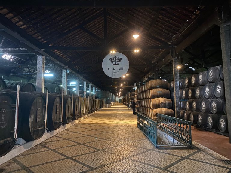 View of a dimly lit corridor lined with large bags and decorative signage.