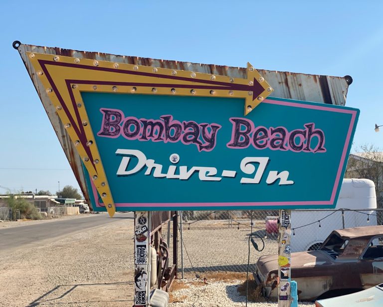 Sign for Bombay Beach Drive-In, featuring bright colours and vintage design.
